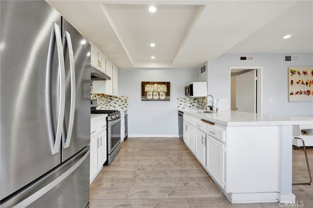 5533 Edward E Horton Ln Unit 6, Encino, CA 91316 - kitchen featuring appliances with stainless steel finishes, under cabinet range hood, a peninsula, recessed lighting, and a kitchen breakfast bar