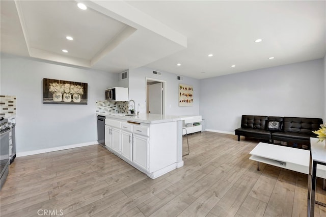 5533 Edward E Horton Ln Unit 6, Encino, CA 91316 - kitchen featuring appliances with stainless steel finishes, light countertops, light wood-style flooring, a peninsula, and recessed lighting