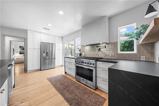 6335 Lorca Dr, San Diego, CA 92115 - kitchen featuring appliances with stainless steel finishes, dark countertops, backsplash, white cabinets, and recessed lighting