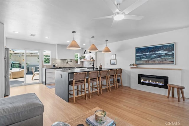 6335 Lorca Dr, San Diego, CA 92115 - living area with light wood-style flooring, a ceiling fan, a glass covered fireplace, and recessed lighting