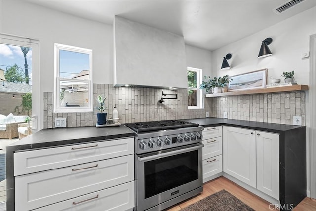 6335 Lorca Dr, San Diego, CA 92115 - kitchen featuring stainless steel range with gas cooktop, dark countertops, light wood-style floors, and open shelves
