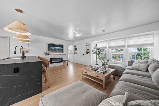 6335 Lorca Dr, San Diego, CA 92115 - living area with wood finished floors, ceiling fan, and a glass covered fireplace