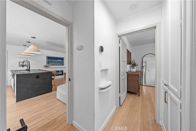 6335 Lorca Dr, San Diego, CA 92115 - hallway featuring light wood-type flooring and a sink