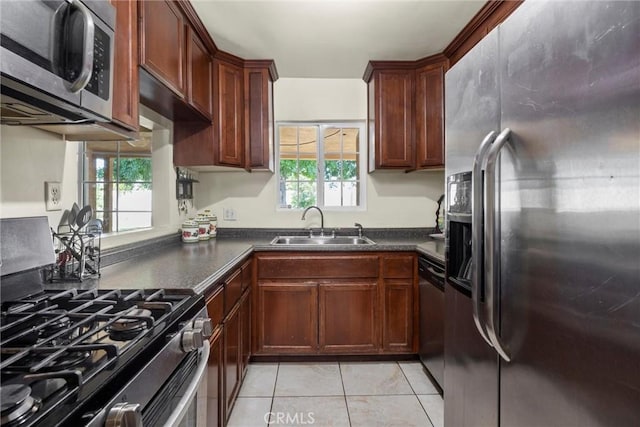 2616 Lynwood St, Bakersfield, CA 93306 - kitchen featuring appliances with stainless steel finishes, dark countertops, and light tile patterned flooring