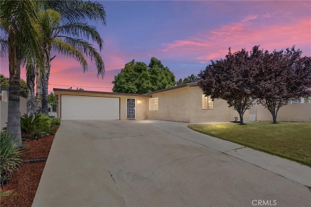 2616 Lynwood St, Bakersfield, CA 93306 - ranch-style home with concrete driveway, stucco siding, a garage, and a yard