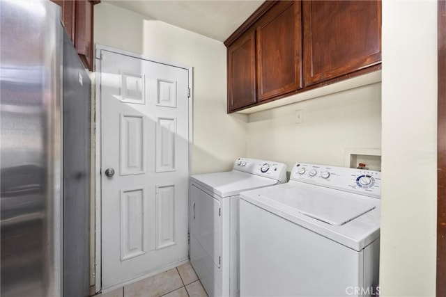 2616 Lynwood St, Bakersfield, CA 93306 - washroom with cabinet space, washing machine and dryer, and light tile patterned floors