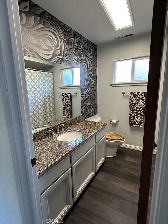 6896 Frontage Rd, Lucerne, CA 95458 - full bathroom with vanity, healthy amount of natural light, and wood finished floors