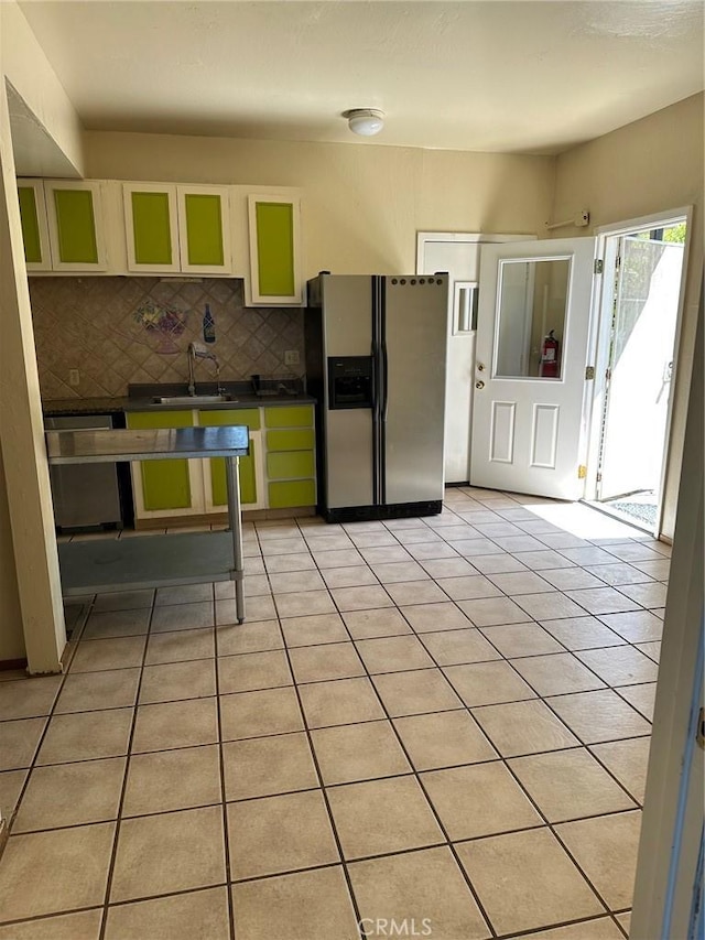 6896 Frontage Rd, Lucerne, CA 95458 - kitchen with stainless steel appliances, dark countertops, decorative backsplash, and light tile patterned floors