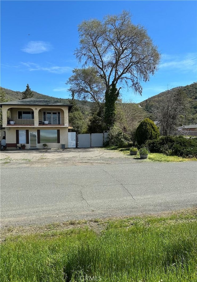 6896 Frontage Rd, Lucerne, CA 95458 - view of side of property featuring stucco siding and a mountain view