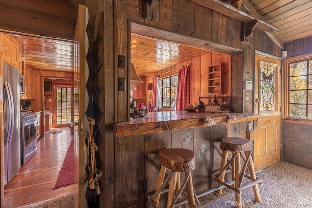 39654 Flicker Rd, Fawnskin, CA 92333 - bar area featuring wood walls, stainless steel appliances, plenty of natural light, wood ceiling, and lofted ceiling
