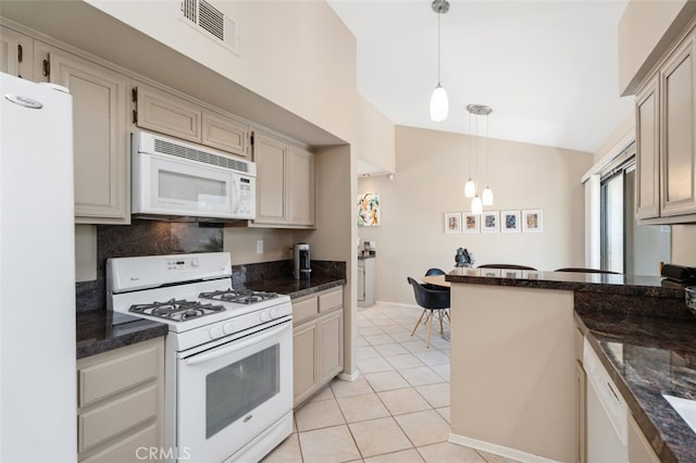 72760 Sage Ct, Palm Desert, CA 92260 - kitchen with white appliances, decorative light fixtures, light tile patterned floors, dark stone counters, and high vaulted ceiling