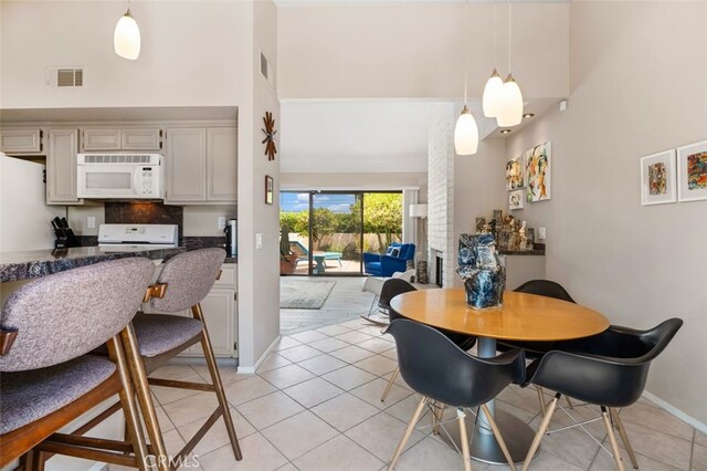 72760 Sage Ct, Palm Desert, CA 92260 - dining room featuring a towering ceiling and light tile patterned flooring