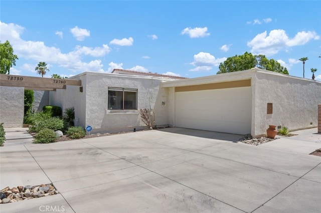 72760 Sage Ct, Palm Desert, CA 92260 - view of front of property with stucco siding, concrete driveway, and an attached garage