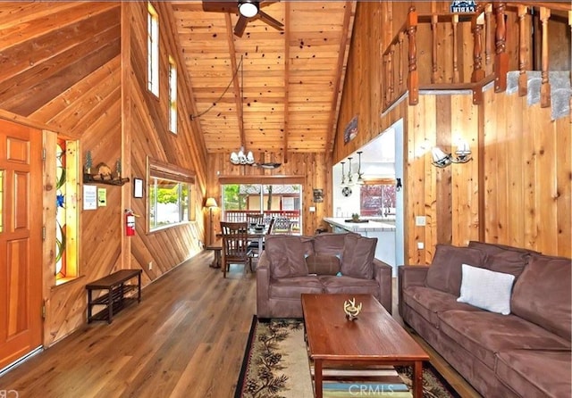 1126 Aleutian Dr, Lake Arrowhead, CA 92352 - living room with hardwood / wood-style flooring, wooden walls, high vaulted ceiling, a chandelier, and a ceiling fan