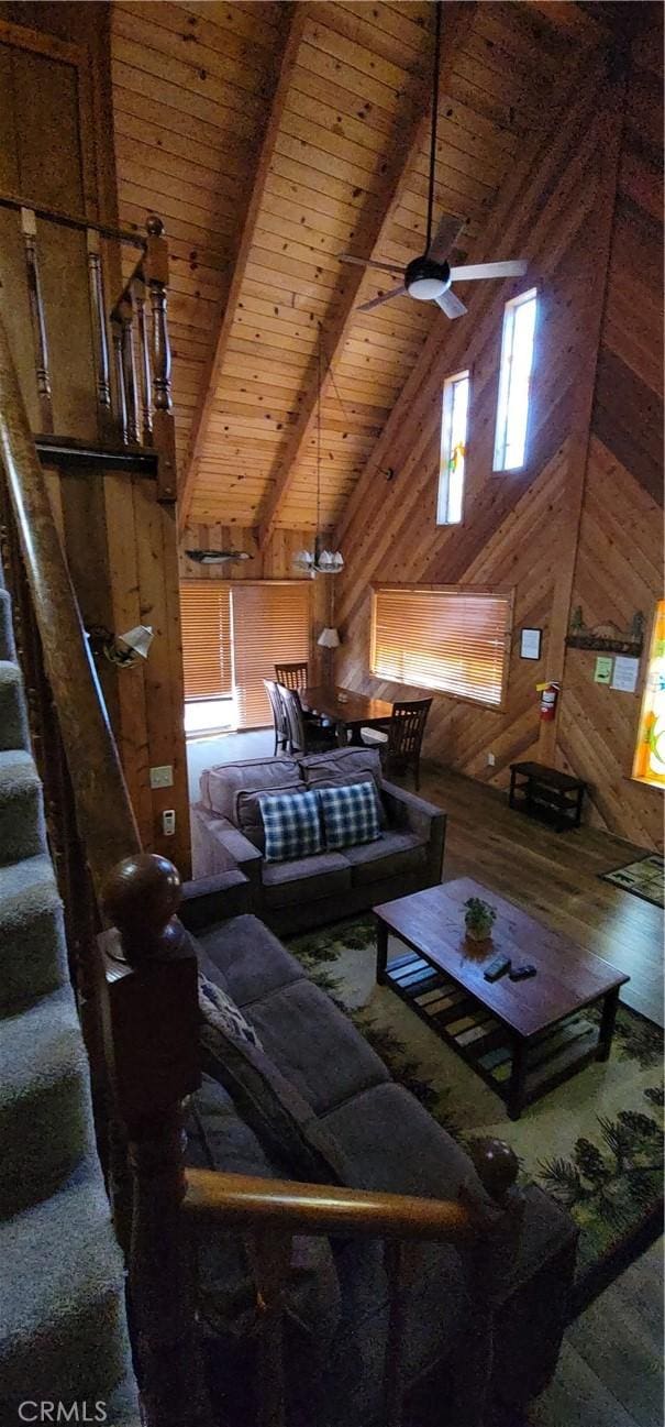 1126 Aleutian Dr, Lake Arrowhead, CA 92352 - living room featuring wood walls, a wood ceiling with exposed beams, stairs, high vaulted ceiling, and a ceiling fan