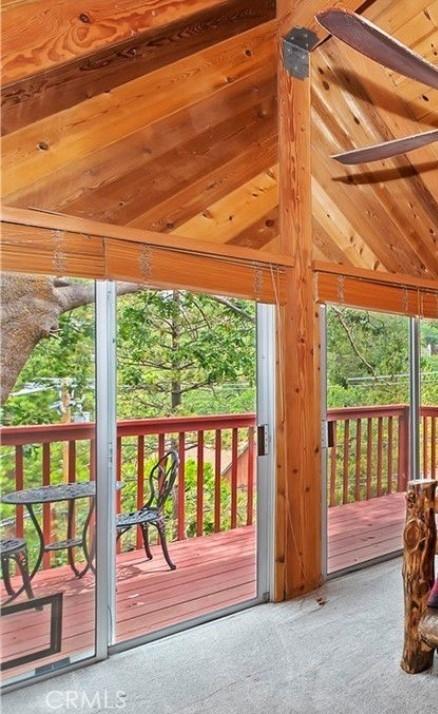 1126 Aleutian Dr, Lake Arrowhead, CA 92352 - doorway to outside with carpet flooring and vaulted ceiling
