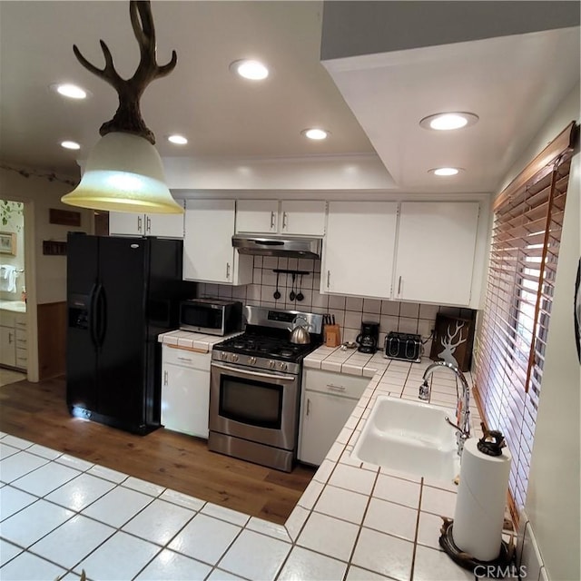 1126 Aleutian Dr, Lake Arrowhead, CA 92352 - kitchen with tile countertops, stainless steel appliances, white cabinetry, light wood-style floors, and recessed lighting