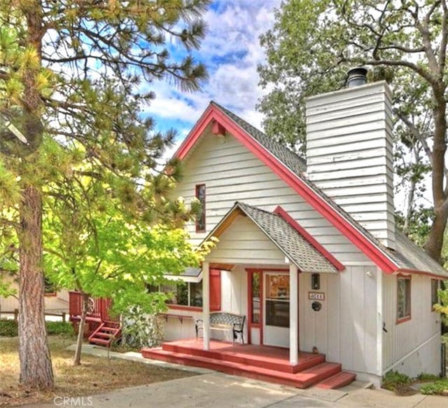 1126 Aleutian Dr, Lake Arrowhead, CA 92352 - back of house featuring a chimney, roof with shingles, and covered porch