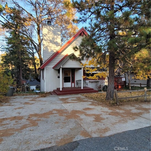 1126 Aleutian Dr, Lake Arrowhead, CA 92352 - view of front of home with a chimney and board and batten siding