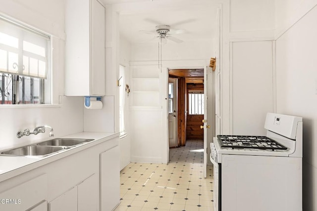 2710 W Shorb St, Alhambra, CA 91803 - kitchen featuring white gas stove, plenty of natural light, a ceiling fan, and white cabinetry