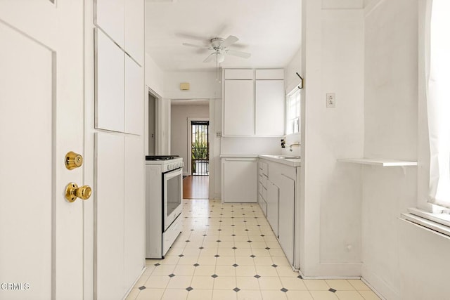 2710 W Shorb St, Alhambra, CA 91803 - kitchen with white range with gas stovetop, a ceiling fan, white cabinets, light countertops, and modern cabinets
