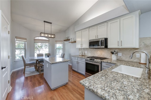 2925 E El Paso Ave, Fresno, CA 93720 - kitchen with appliances with stainless steel finishes, tasteful backsplash, healthy amount of natural light, light stone counters, and vaulted ceiling