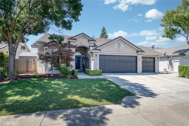 2925 E El Paso Ave, Fresno, CA 93720 - view of front of home featuring an attached garage, stucco siding, driveway, and a tile roof