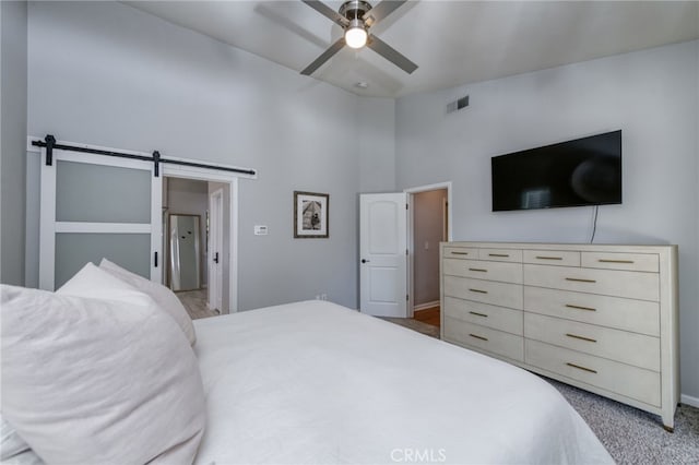 2925 E El Paso Ave, Fresno, CA 93720 - bedroom featuring a barn door, a towering ceiling, carpet flooring, and a ceiling fan