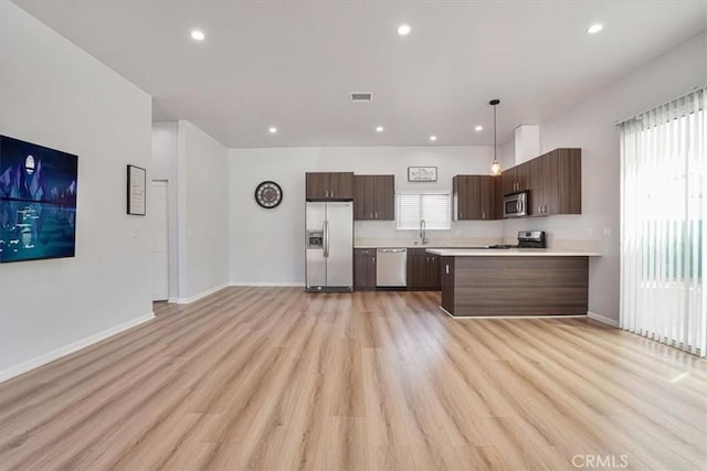 7820 Fulton Ave, North Hollywood, CA 91605 - kitchen featuring stainless steel appliances, light countertops, dark brown cabinetry, healthy amount of natural light, and recessed lighting