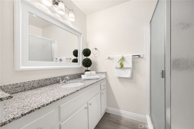 3020 Associated Rd Unit 110, Fullerton, CA 92835 - full bathroom featuring vanity, a shower stall, and wood finished floors