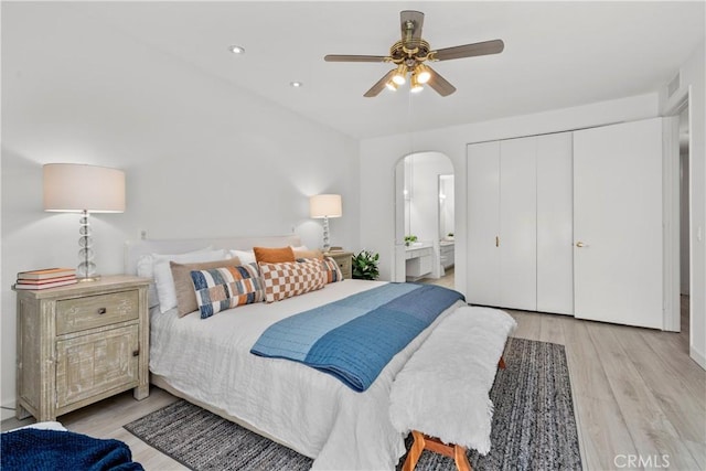 4949 Genesta Ave Unit 102, Encino, CA 91316 - bedroom featuring arched walkways, light wood finished floors, ensuite bath, a closet, and ceiling fan