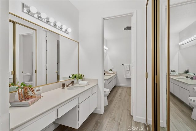 4949 Genesta Ave Unit 102, Encino, CA 91316 - full bathroom featuring two vanities and wood finished floors