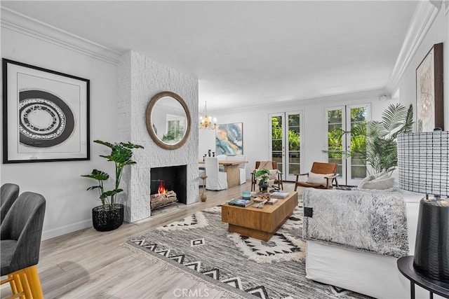 4949 Genesta Ave Unit 102, Encino, CA 91316 - living room featuring crown molding, wood finished floors, a fireplace, and a chandelier