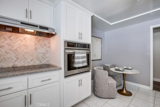1354 Shadow Ln Unit 102, Fullerton, CA 92831 - kitchen with stainless steel oven, under cabinet range hood, black electric cooktop, and white cabinetry