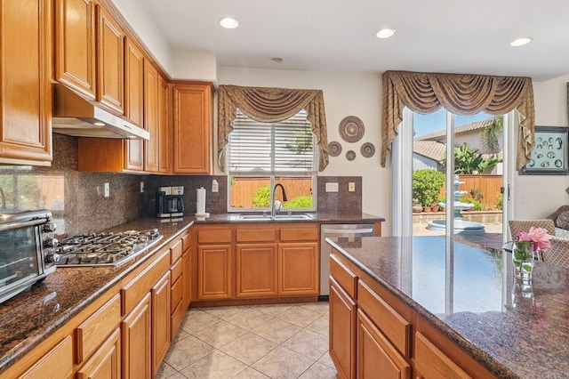 568 Scenic Trail Pl, Chula Vista, CA 91914 - kitchen with stainless steel appliances, under cabinet range hood, plenty of natural light, brown cabinetry, and recessed lighting