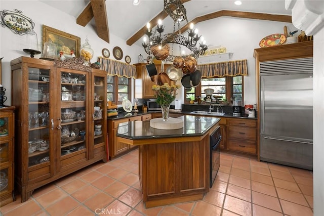 665 Sheehy Rd, Nipomo, CA 93444 - kitchen featuring appliances with stainless steel finishes, dark countertops, brown cabinets, a kitchen island, and light tile patterned flooring
