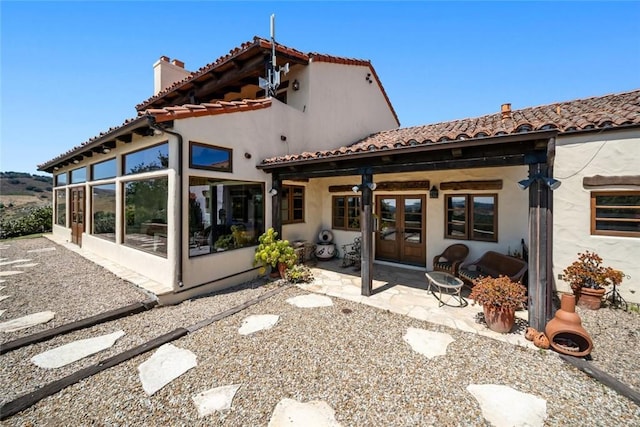 665 Sheehy Rd, Nipomo, CA 93444 - back of property with french doors, a sunroom, a chimney, a patio area, and a tiled roof