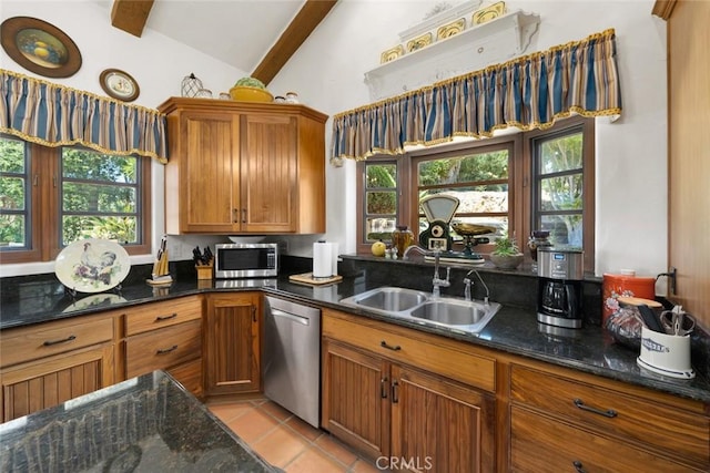 665 Sheehy Rd, Nipomo, CA 93444 - kitchen with appliances with stainless steel finishes, brown cabinetry, dark stone counters, light tile patterned floors, and healthy amount of natural light