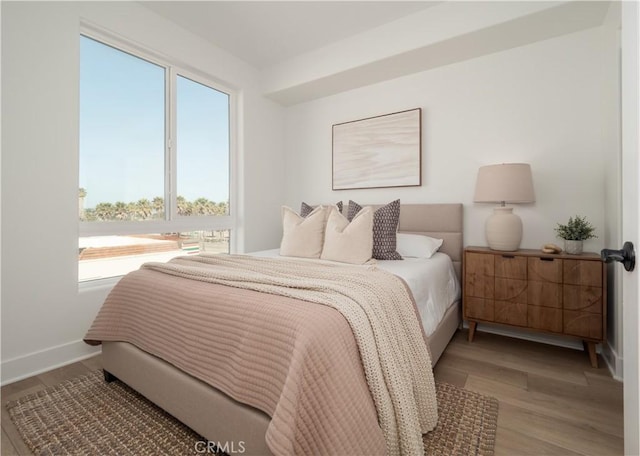 402 W Grand Ave Unit 104, Grover Beach, CA 93433 - bedroom with multiple windows and wood finished floors