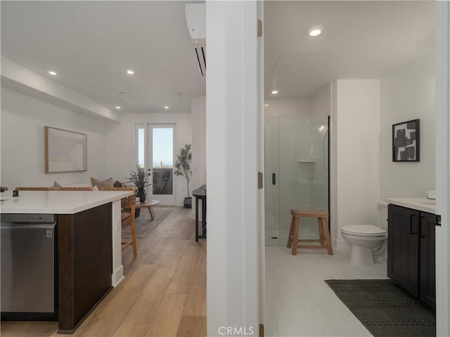 402 W Grand Ave Unit 104, Grover Beach, CA 93433 - full bathroom with vanity, a stall shower, recessed lighting, a freestanding bath, and wood finished floors