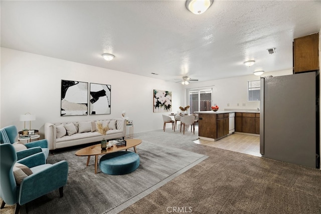 642 W 1st Ave, Chico, CA 95926 - living room with light carpet, a ceiling fan, and a textured ceiling