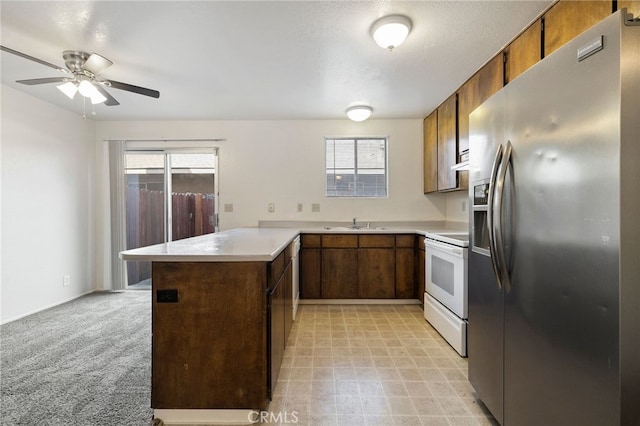 642 W 1st Ave, Chico, CA 95926 - kitchen featuring stainless steel fridge with ice dispenser, white range with electric stovetop, a peninsula, light countertops, and ceiling fan