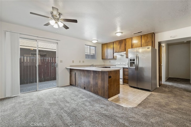 642 W 1st Ave, Chico, CA 95926 - kitchen with stainless steel refrigerator with ice dispenser, white electric stove, a peninsula, under cabinet range hood, and light colored carpet