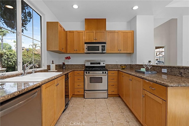 26675 Country Creek Ln, Calabasas, CA 91302 - kitchen featuring stainless steel appliances, a peninsula, dark stone counters, and recessed lighting