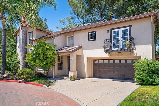 26675 Country Creek Ln, Calabasas, CA 91302 - view of front of home with a balcony, stucco siding, a garage, driveway, and a tiled roof