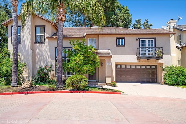 26675 Country Creek Ln, Calabasas, CA 91302 - view of front facade with stucco siding, concrete driveway, and a balcony