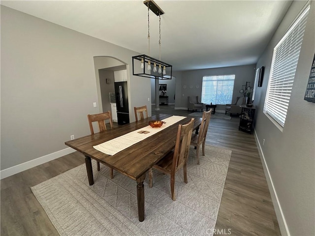 2775 Canyon View Cir, Corona, CA 92882 - dining space with wood finished floors, arched walkways, and a chandelier
