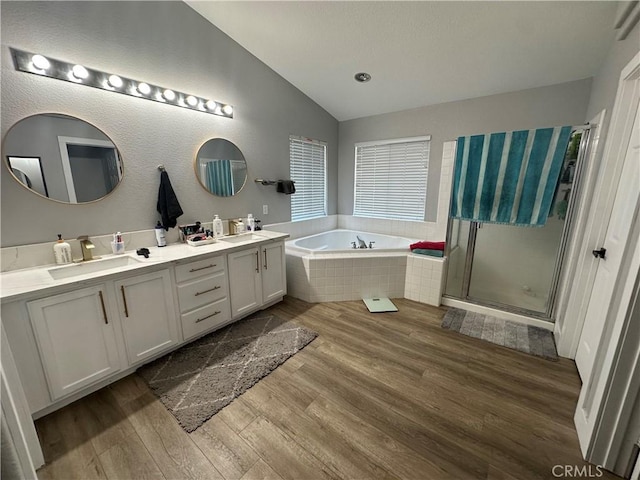 2775 Canyon View Cir, Corona, CA 92882 - full bathroom with vaulted ceiling, double vanity, wood finished floors, a garden tub, and a shower stall