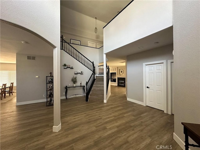2775 Canyon View Cir, Corona, CA 92882 - stairs with arched walkways, wood finished floors, and a high ceiling