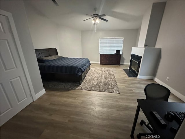 2775 Canyon View Cir, Corona, CA 92882 - bedroom featuring light wood-style floors, a fireplace with flush hearth, and ceiling fan